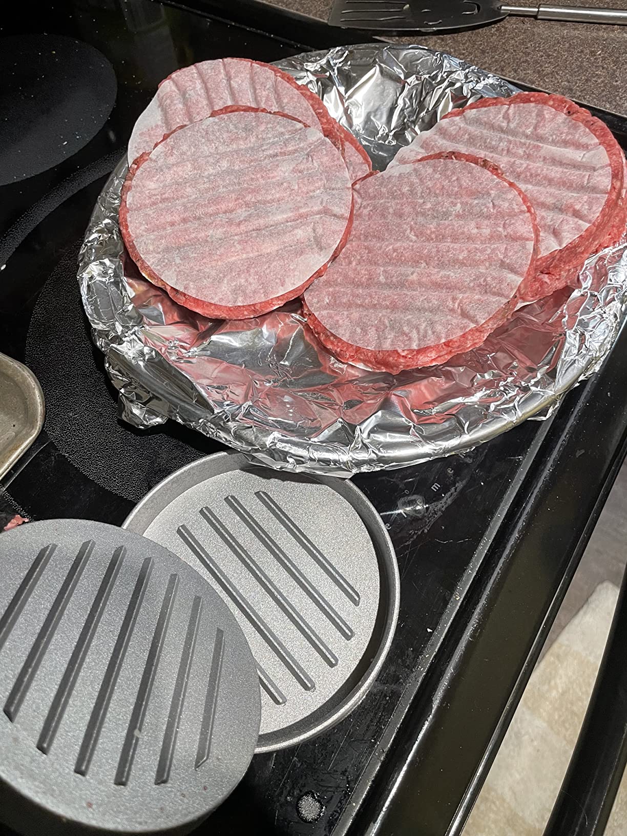 Prepared burger patties stacked with round patty papers